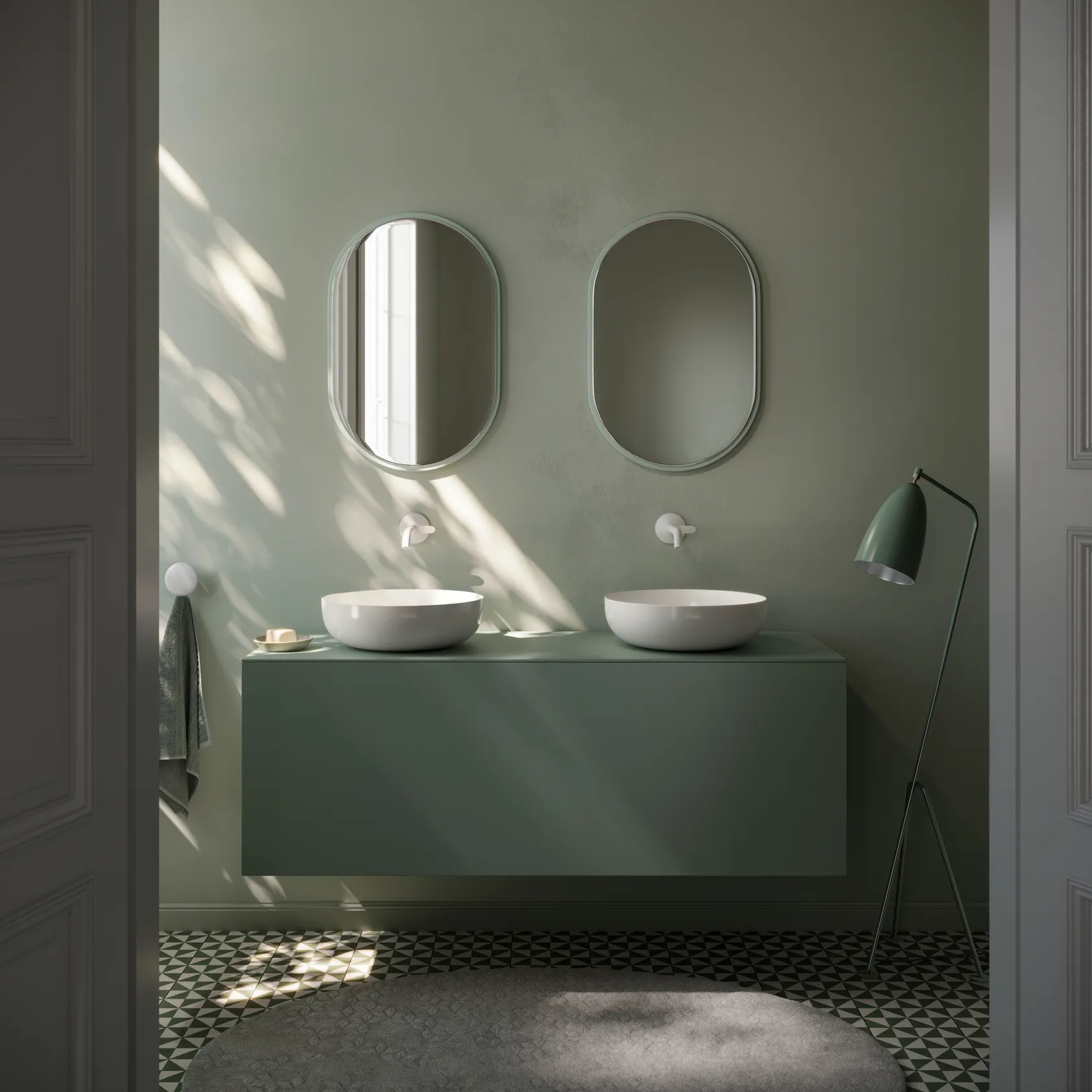 Zwei Runde Waschbecken in einem Badezimmer mit grünen Teint
